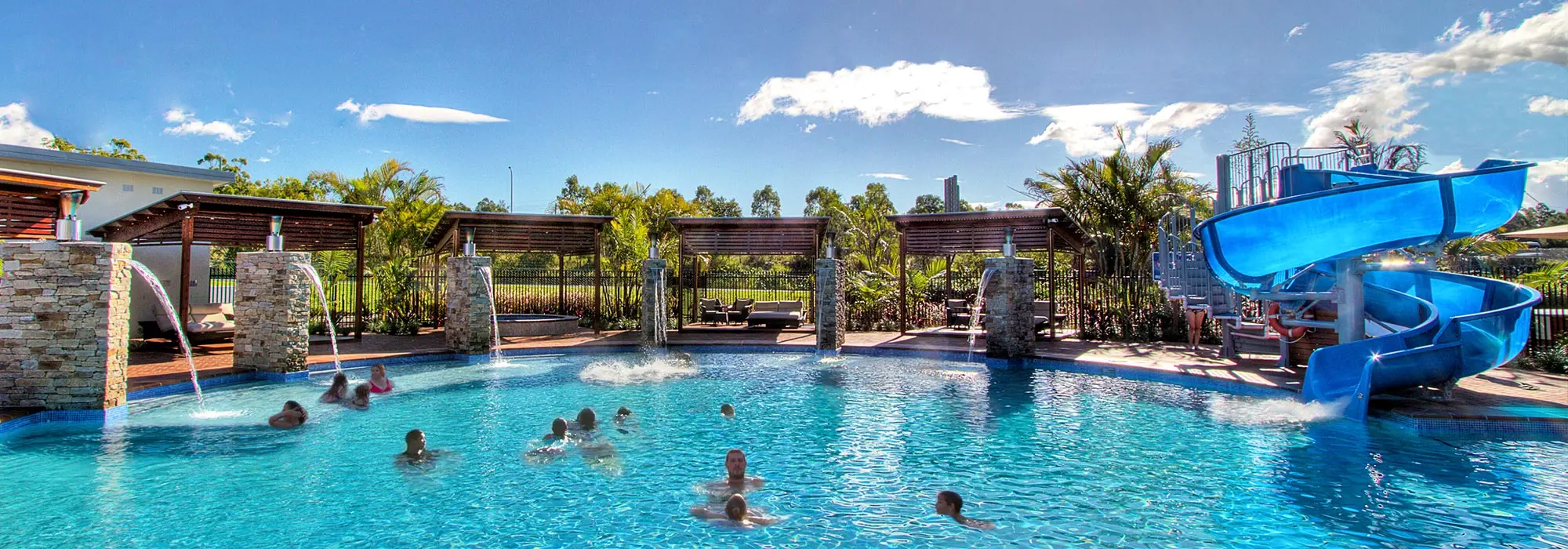 Aquatic water slide installation with bright blue water
